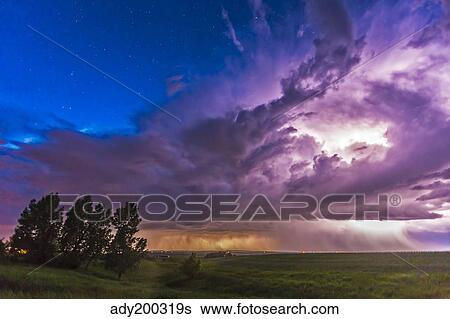 Stock Photograph - A massive thunderstorm lit internally by lightning.. Fotosearch