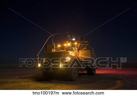 A MaxxPro MRAP vehicle with running lights on at night. View Large Photo Image Picture - A MaxxPro MRAP vehicle with running lights on at night.. Fotosearch