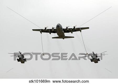 A MC-130W conducts an in-flight refueling for two MH-53J Pave Low III helicopters. View Large Photo Image Picture - A MC-130W conducts an in-flight refueling for two MH-53J Pave Low III helicopters.. Fotosearch