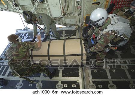 Picture - A member from the Pathfinder Platoon gets ready to jump from a C-130 transport plane with a container.. Fotosearch