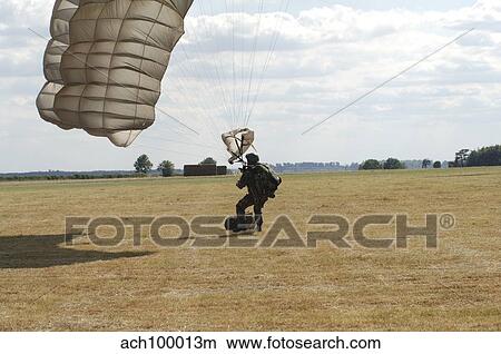 A member of the Pathfinder Platoon collapses his parachute after a HALO jump. View Large Photo Image Picture - A member of the Pathfinder Platoon collapses his parachute after a HALO jump.. Fotosearch