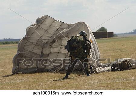 A member of the Pathfinder Platoon collapses his parachute after a HALO jump. View Large Photo Image Picture - A member of the Pathfinder Platoon collapses his parachute after a HALO jump.. Fotosearch