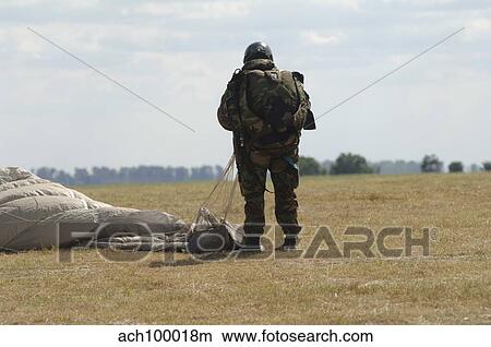 A member of the Pathfinder Platoon collapses his parachute after a HALO jump. View Large Photo Image Picture - A member of the Pathfinder Platoon collapses his parachute after a HALO jump.. Fotosearch