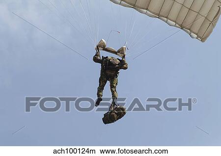 A member of the Pathfinder Platoon prepares to land from a parachute jump. View Large Photo Image Picture - A member of the Pathfinder Platoon prepares to land from a parachute jump.. Fotosearch