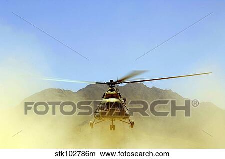 Picture - A Mi-17 Hip helicopter hovers over a firing range in Afghanistan.. Fotosearch