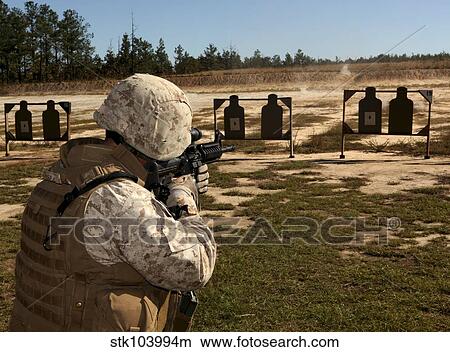 A military policeman fires a rifle at the shooting range. View Large Photo Image Picture - A military policeman fires a rifle at the shooting range.. Fotosearch