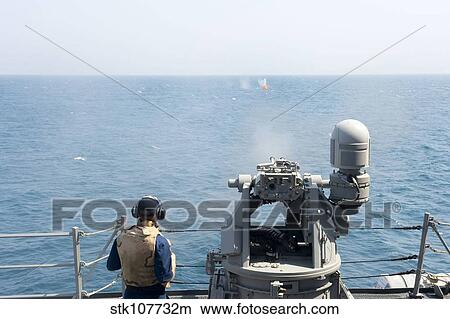 Picture - A MK-38 25mm machine gun is fired aboard USS William P. Lawrence.. Fotosearch