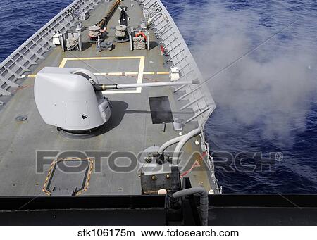 A Mk-45 5-inch. 54-caliber gun is fired aboard USS Cowpens. View Large Photo Image Picture - A Mk-45 5-inch. 54-caliber gun is fired aboard USS Cowpens.. Fotosearch