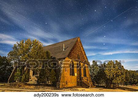 Stock Photograph - A moonlit nightscape of the historic Hearst Church in Pinos Altos, New Mexico.. Fotosearch