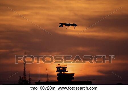Picture - A MQ-1 Predator over COB Speicher at sunset, Tikrit, Iraq.. Fotosearch