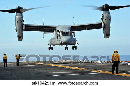 A MV-22 Osprey aircraft prepares to land on the flight deck. View Large Photo Image Picture - A MV-22 Osprey aircraft prepares to land on the flight deck.. Fotosearch