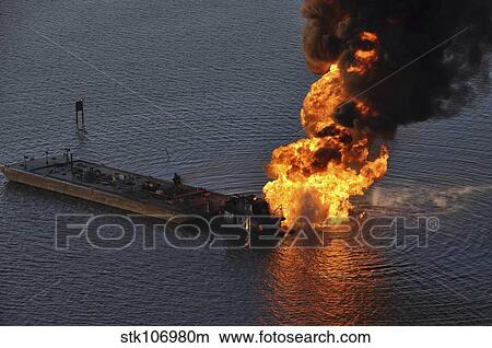 Picture - A natural gas pipeline burns after being struck by the tugboat Shannon E. Setoon.. Fotosearch