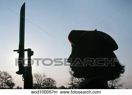 Picture - A Navy Flying Rifles Drill Team member stands at attention holding the M1 Garrand rifle.. Fotosearch