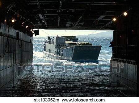 A Navy Landing Craft Utility approaches the well deck of USS Tarawa off the coast of Hawaii. View Large Photo Image Picture - A Navy Landing Craft Utility approaches the well deck of USS Tarawa off the coast of Hawaii.. Fotosearch