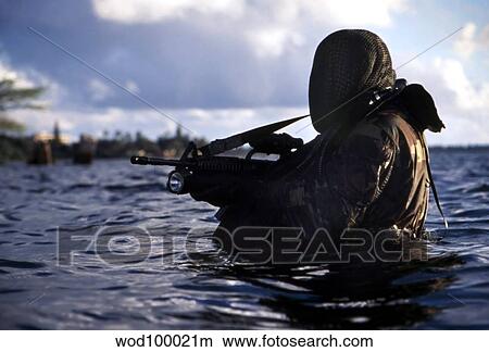 A Navy SEAL emerges from underwater during a training exercise. View Large Photo Image Picture - A Navy SEAL emerges from underwater during a training exercise.. Fotosearch