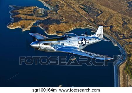 A North American P-51D Mustang flying near Chino, California. View Large Photo Image Picture - A North American P-51D Mustang flying near Chino, California.. Fotosearch