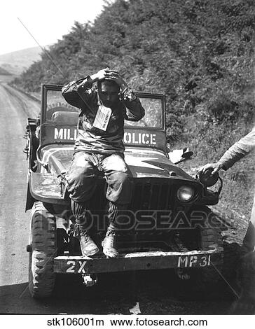 A North Korean prisoner of war sits on a military police vehicle. View Large Photo Image Picture - A North Korean prisoner of war sits on a military police vehicle.. Fotosearch
