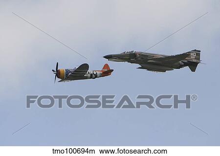A P-47 Thunderbolt and an F-4 Phantom in flight. View Large Photo Image Picture - A P-47 Thunderbolt and an F-4 Phantom in flight.. Fotosearch