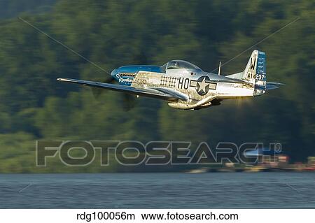 A P-51 Mustang flies along the Mississippi at Dubuque, Iowa. View Large Photo Image Picture - A P-51 Mustang flies along the Mississippi at Dubuque, Iowa.. Fotosearch