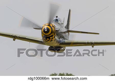 A P-51 Mustang flies by at East Troy, Wisconsin. View Large Photo Image Picture - A P-51 Mustang flies by at East Troy, Wisconsin.. Fotosearch