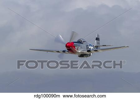A P-51 Mustang flies by at Half Moon Bay, California. View Large Photo Image Picture - A P-51 Mustang flies by at Half Moon Bay, California.. Fotosearch
