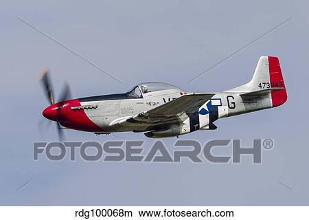 A P-51 Mustang flies by at Willow Run, Michigan. View Large Photo Image Picture - A P-51 Mustang flies by at Willow Run, Michigan.. Fotosearch