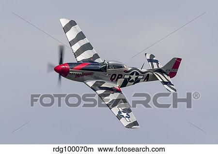 A P-51 Mustang flies by at Willow Run, Michigan. View Large Photo Image Picture - A P-51 Mustang flies by at Willow Run, Michigan.. Fotosearch