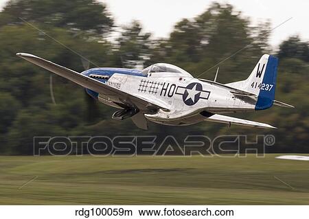 A P-51 Mustang takes off from Waukegan, Illinois. View Large Photo Image Picture - A P-51 Mustang takes off from Waukegan, Illinois.. Fotosearch