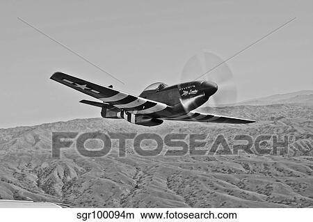 A P-51D Mustang in flight over Hollister, California. View Large Photo Image Picture - A P-51D Mustang in flight over Hollister, California.. Fotosearch