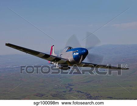 A P-51D Mustang in flight over Hollister, California. View Large Photo Image Picture - A P-51D Mustang in flight over Hollister, California.. Fotosearch