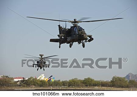 A pair of AH-64D Apache Longbow helicopters taking off. View Large Photo Image Picture - A pair of AH-64D Apache Longbow helicopters taking off.. Fotosearch
