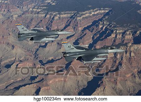 A pair of F-16's fly in formation near the Grand Canyon, Arizona. View Large Photo Image Picture - A pair of F-16's fly in formation near the Grand Canyon, Arizona.. Fotosearch