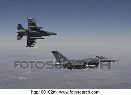 A pair of F-16's fly in formation over Arizona. View Large Photo Image Picture - A pair of F-16's fly in formation over Arizona.. Fotosearch