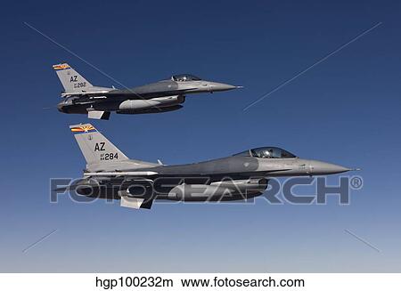 Picture - A pair of F-16's fly in formation over Arizona.. Fotosearch