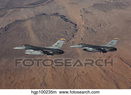 Picture - A pair of F-16's fly in formation over Arizona.. Fotosearch