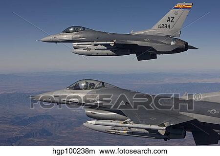 A pair of F-16's fly in formation over Arizona. View Large Photo Image Picture - A pair of F-16's fly in formation over Arizona.. Fotosearch