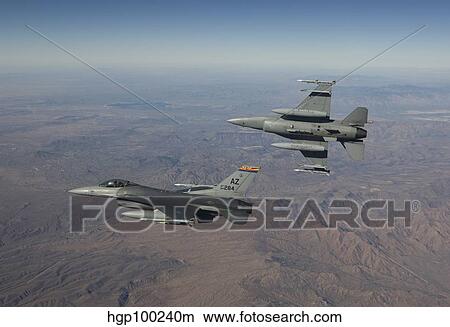 A pair of F-16's fly in formation over Arizona. View Large Photo Image Picture - A pair of F-16's fly in formation over Arizona.. Fotosearch