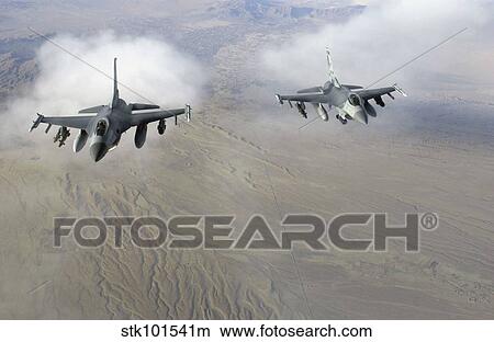 A pair of U. S. Air Force F-16C Fighting Falcons in flight over Afghanistan. View Large Photo Image Picture - A pair of U. S. Air Force F-16C Fighting Falcons in flight over Afghanistan.. Fotosearch