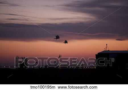 A pair of UH-60 Black Hawk helicopters approach their landing in Baghdad, Iraq. View Large Photo Image Picture - A pair of UH-60 Black Hawk helicopters approach their landing in Baghdad, Iraq.. Fotosearch