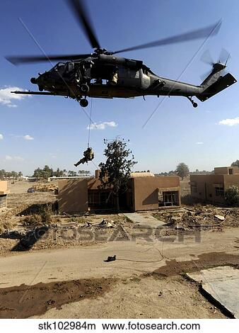 Picture - A pararescueman rappels from an HH-60 Pavehawk helicopter.. Fotosearch