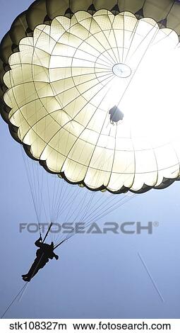 Picture - A paratrooper descends onto the drop zone.. Fotosearch