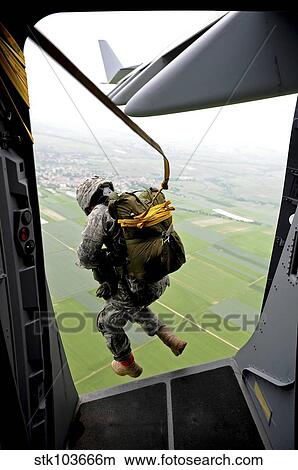 A paratrooper executes an airborne jump out of a C-17 Globemaster III. View Large Photo Image Picture - A paratrooper executes an airborne jump out of a C-17 Globemaster III.. Fotosearch