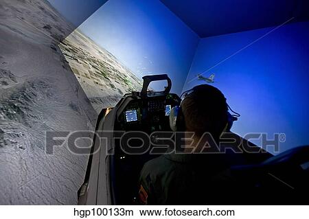 A pilot flies the F-16 simulator. View Large Photo Image Picture - A pilot flies the F-16 simulator.. Fotosearch