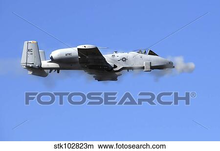 Picture - A pilot in an A-10 Thunderbolt II fires the plane's 30-mm cannon.. Fotosearch