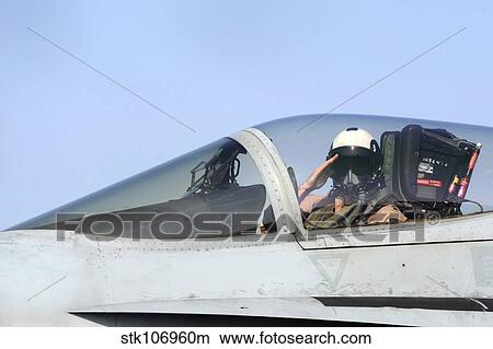 A pilot salutes prior to take off in an F/A-18C Hornet. View Large Photo Image Picture - A pilot salutes prior to take off in an F/A-18C Hornet.. Fotosearch