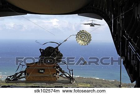 A practice pallet is released from the back of a C-17 Globemaster III. View Large Photo Image Picture - A practice pallet is released from the back of a C-17 Globemaster III.. Fotosearch