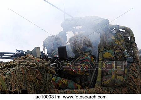 A recce or scout team of the Belgian Army in action under a smoke curtain. View Large Photo Image Picture - A recce or scout team of the Belgian Army in action under a smoke curtain.. Fotosearch