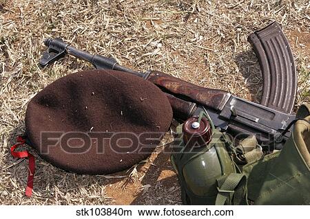 A rifle, military cover and canteen of a Mozambican soldier. View Large Photo Image Picture - A rifle, military cover and canteen of a Mozambican soldier.. Fotosearch