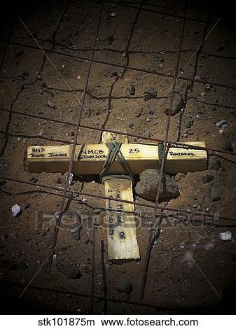 A road repair crew places a cross inside a road crater. View Large Photo Image Picture - A road repair crew places a cross inside a road crater.. Fotosearch