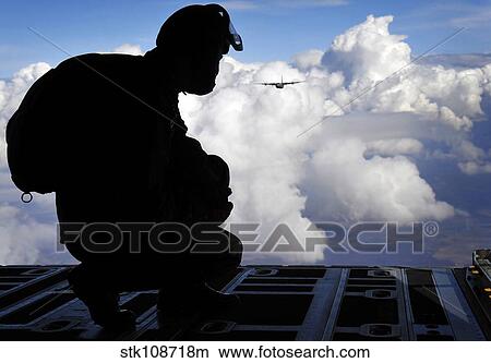 A Romanian paratrooper awaits his signal to jump out of a C-130J Super Hercules. View Large Photo Image Picture - A Romanian paratrooper awaits his signal to jump out of a C-130J Super Hercules.. Fotosearch